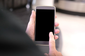 hand holding mobile smart phone at airport