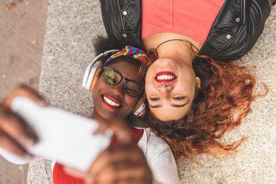 Two Teenage Female Friends Taking a Selfie Outdoors.