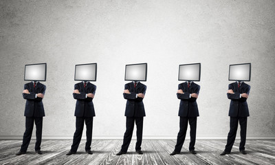 Businessmen with monitors instead of head.