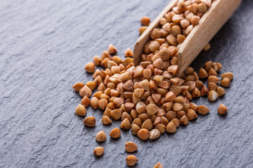 Grain buckwheat on a dark stone background