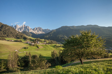 Obraz premium Small Italian mountain town of St. Magdalena in Val di Funes at sunset