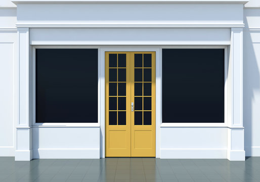 Classic shopfront with yellow door and large windows. Small business white store facade