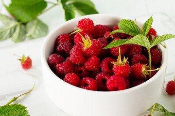 Berry raspberries on the kitchen wooden table. Concept fruit dessert and healthy dieting.
