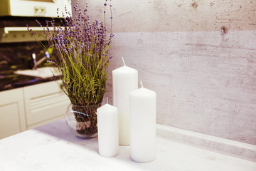 kitchen interior with white candle and lavender.