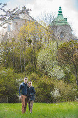 couple posing in front of old castle