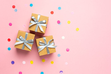 Gift or present boxes and color confetti on pink table. Flat lay composition for birthday, mother day or wedding