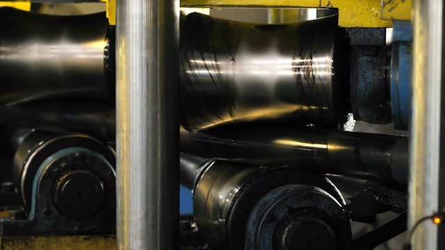 Tube Rolling Machine At The Factory. The machine aligns the metal pipe