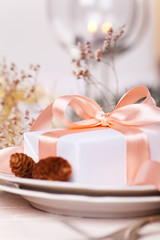 Fototapeta na wymiar Serving festive table with gift box