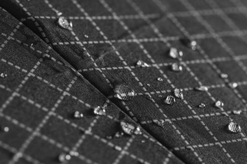 Rain Water droplets on a black waterproof fabric