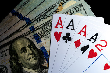 Four aces Playing Cards and Stack of 100 American Dollars Bills.