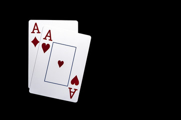 Two aces playing cards on black table