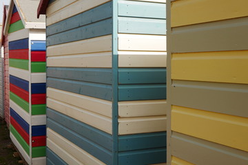 Colourful striped wooden beach huts at Budleigh Salterton, Devon, England