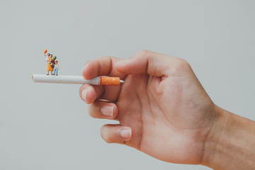 World no tobacco day. Cigarette and family figure. a concept for stop smoking. Smoking a cigarette...
