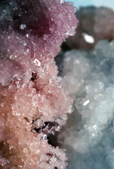 Gemstone closeup as a part of a cluster filled with rock crystals.