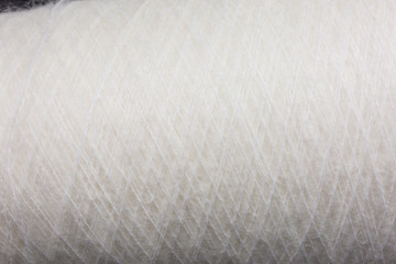 Fototapeta na wymiar background of fluffy white mohair wool on a cone
