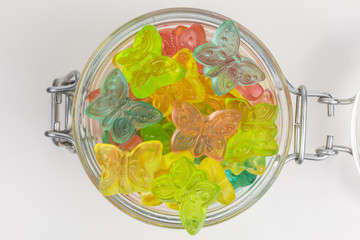 gummy candy butterflies in pink, yellow, green and blue in a glass jar