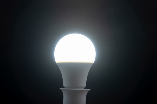 Daylight white led bulb on black background