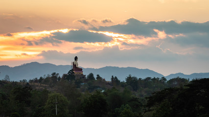 Fototapeta na wymiar great Buddha statue on the hilltop in the evening, Myawaddy, Myanmar