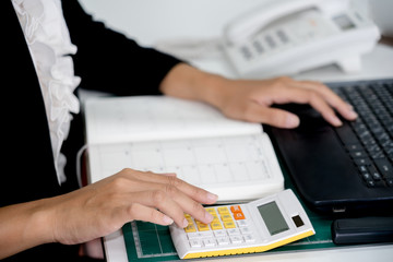 businesswoman working using a calculator in a desk at office