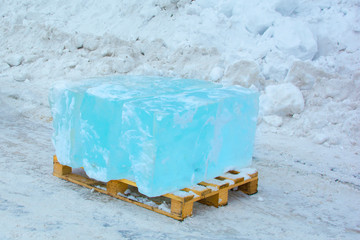 blocks of clear ice, cut off for ice sculpture. Loaded on wooden pallets