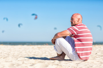 Nautical theme.Sea tour. North sea. A young man resting on the beach.Germany. 