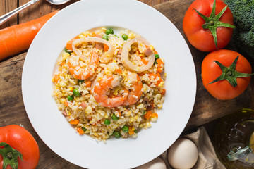 Seafood fried rice on wooden background，Thai Food ，Shrimp fried rice.