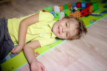 A Creative kindergarten kids build a block tower.