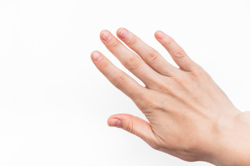 female hand with short nails and neat manicure without varnish on a white background, arthrosis of the joints, normal skin