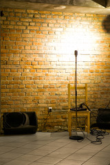 Microphone ready on stage against a brick wall ready for the Karaoke performer