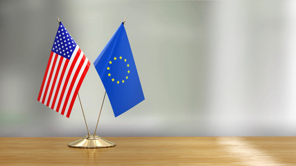 American and European Union flag pair on a desk over defocused background  - 266168407