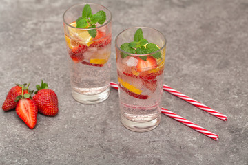 Refreshing Ice Cold Strawberry Lemonade on grey table