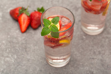 Refreshing Ice Cold Strawberry Lemonade on grey table