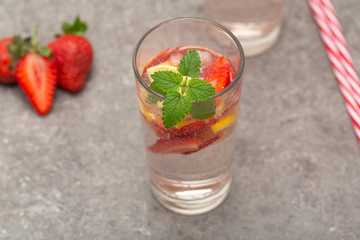 Refreshing Ice Cold Strawberry Lemonade on grey table