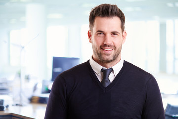 Fototapeta premium Casual businessman portrait while standing in the office