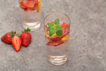 Refreshing Ice Cold Strawberry Lemonade on grey table