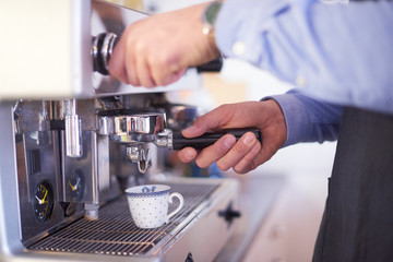 Close-up of water's hand while brewing coffee