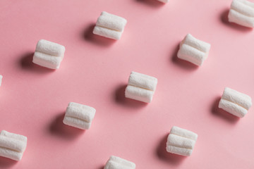 composition of marshmallow on the pink table, top view, creative design.