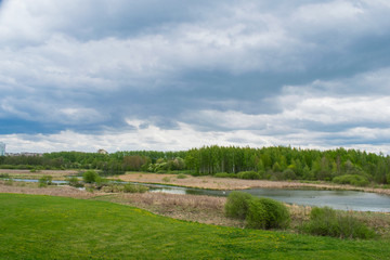 spring landscape river forest trees against a blue sky