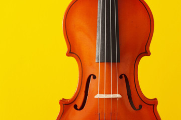 Classical music concert poster with orange color violin on yellow background with copy space for your text