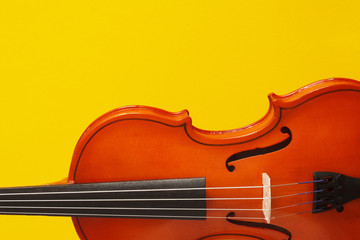 Classical music concert poster with orange color violin on yellow background with copy space for your text