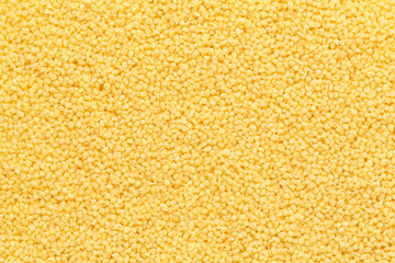 Dry couscous texture. Close up couscous grains background. Top view 