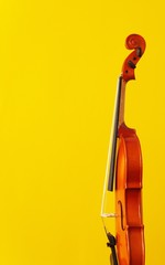 Classical music concert poster with orange color violin on yellow background with copy space for...