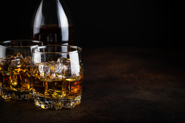Whiskey in the glasses on black.