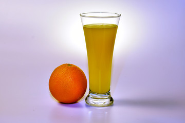 Glass with orange juice and orange