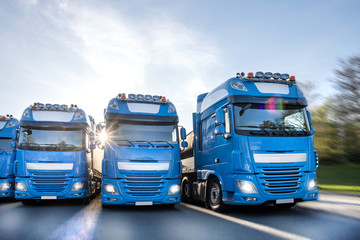 blue trucks speeding in line composing