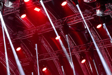 Colorful concert lighting. Rays of light from concert lighting on a dark background above the projector screen.