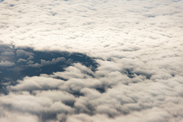 Clouds from a window of a commercial plane with sea.