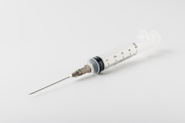 medical syringe with a long needle for the treatment of diseases and beauty shots on a white...