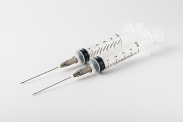 medical syringe with a long needle for the treatment of diseases and beauty shots on a white...