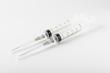 medical syringe with a long needle for the treatment of diseases and beauty shots on a white background